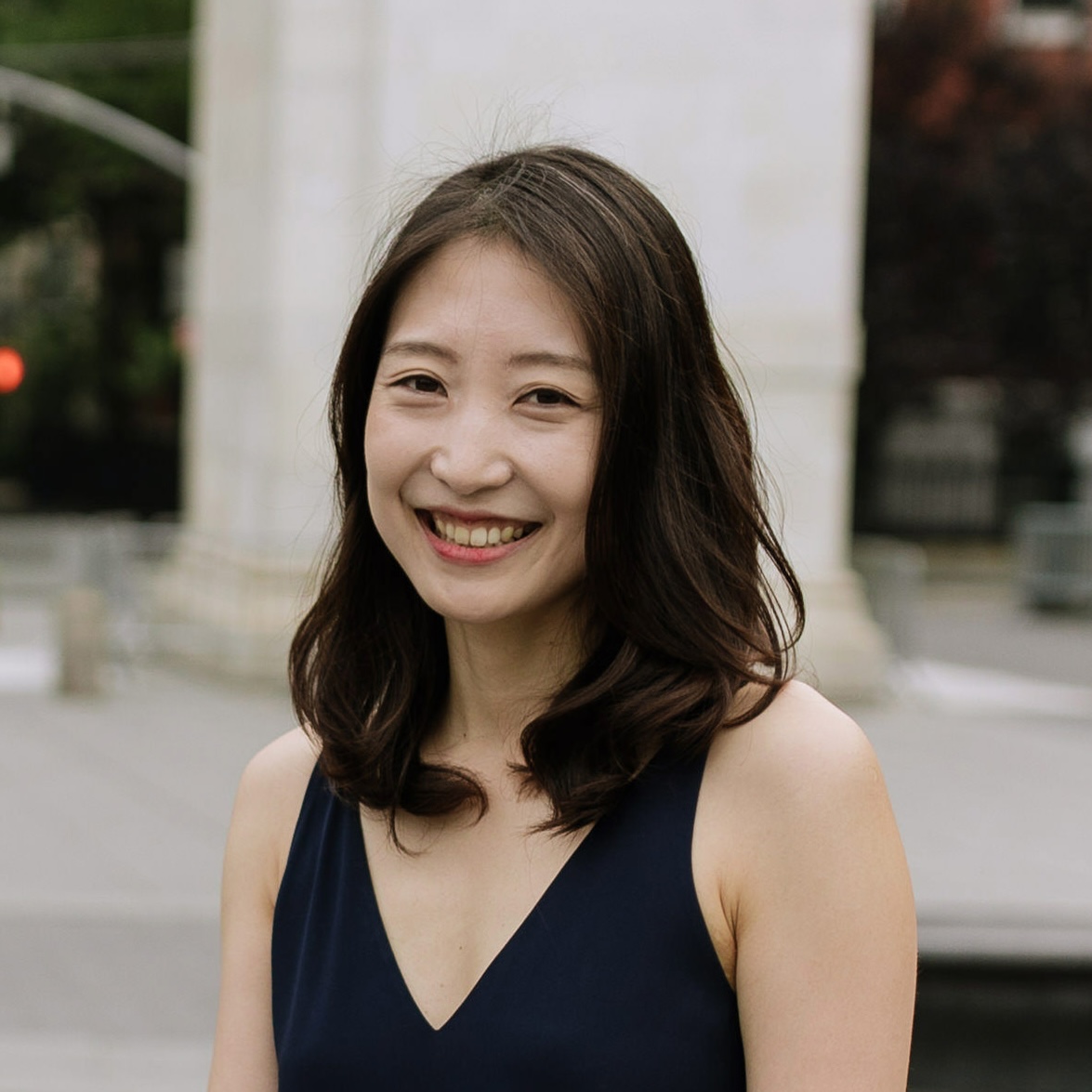 Profile picture for Eunsol Choi. She has black hair, is wearing a navy top, and is smiling in front of the Washington Square Arch.